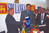 H.E Mr Karunatilake Amunugama Ambassador for Sri Lanka in China being presented with a Memento by the ‘N.G.J.A’ Representative