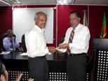 The Chairman NGJA, handing over the 100th pack of pure silver to Mr D.M.B.Piyasiri