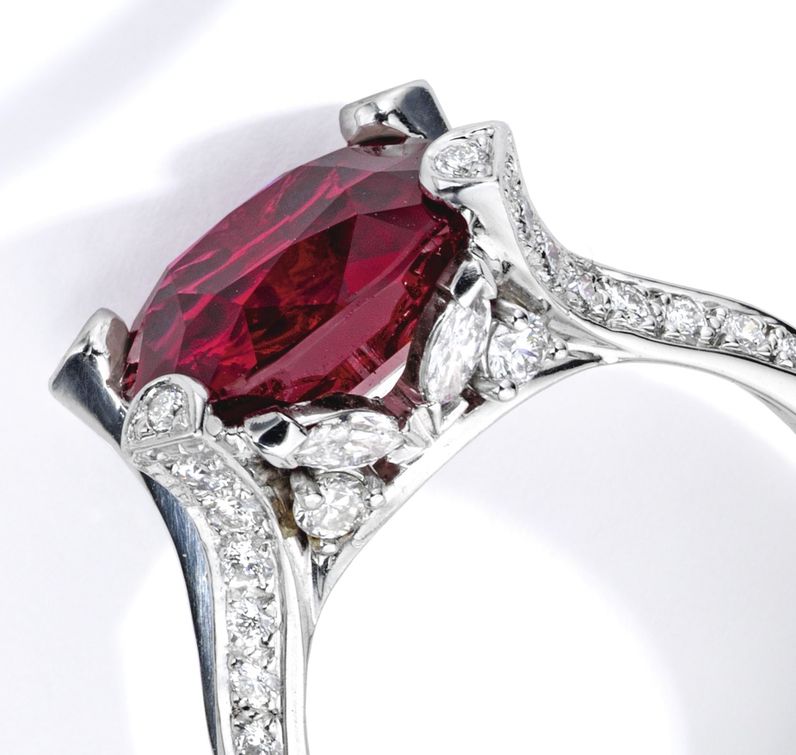 Lot 57 - Platinum, Ruby and Diamond Ring, Van Cleef & Arpels. Marquise and round-cut diamonds mounted as side stones are shown.