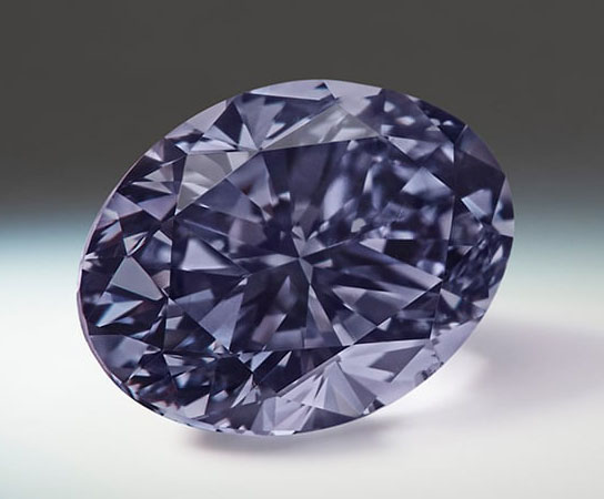 Lot 6 - Argyle Infinite - A 0.70-carat, oval-shaped, Fancy Dark Violet-Gray diamond.