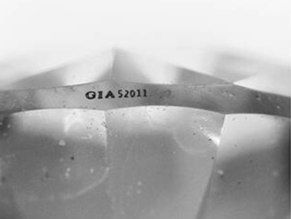 synthetic moissanite wiith fradulent GIA inscription partially redacted